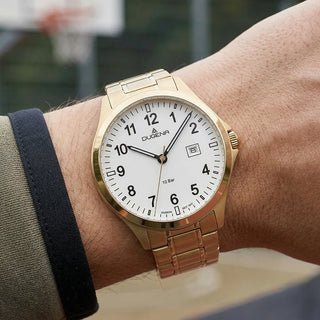 Goldfarbene Dugena Boston Herrenuhr mit weißem Zifferblatt und Edelstahlarmband am Handgelenk