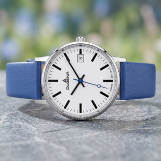 Dugena MOMA 4461208 mit blauem Lederband, weißem Zifferblatt und blauem Sekundenzeiger auf einer Steinoberfläche